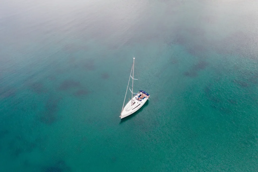 sailing boat on rippled sea background aerial dro 2024 12 07 15 34 21 utc